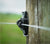 Fence post with wire tensioner attached, used for maintaining tension on a fence line.