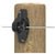 Black electric fence insulator attached to a wooden post with a white background