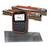Gallagher TW-3 electronic cattle and livestock scale system with a black and orange casing stands in front of two alleyway load bars on a white background, with a textured metal platform in front of it.