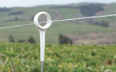 white top Gallagher H.D. Ring Top Fence Post on ranch with pasture in background